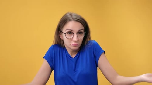 Funny Doubtful Blonde Woman Uncertain Making Gesture Don't Know Posing Isolated on Orange Studio