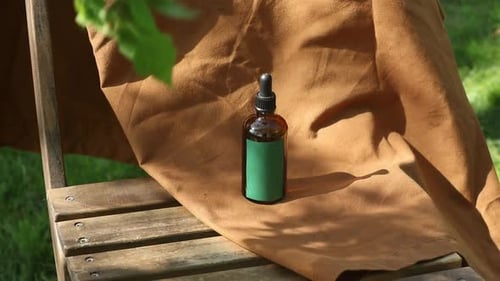 Brown Bottle With Dropper on Wood Surface