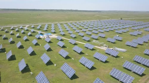 Aerial View of Solar Power Station. Drone Flight Over Solar Panels Field. Renewable Green
