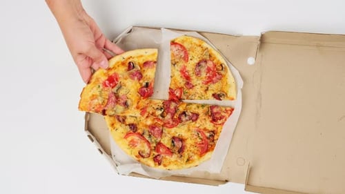 Hand Takes Pizza Slice Out Of Box