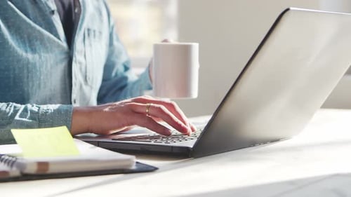 Young male entrepreneur works at home office at the computer.