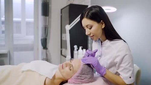 Woman Receiving Facial Treatment at a Clinic