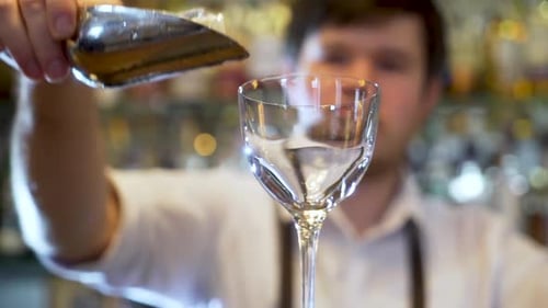 Bartender Preparing Alcoholic Cocktail Drink at Bar