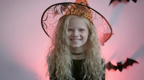 Smiling Girl in Witch Costume on Halloween