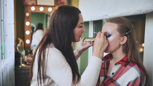 Makeup Artist Applying Colorful Eye Shadow to Model