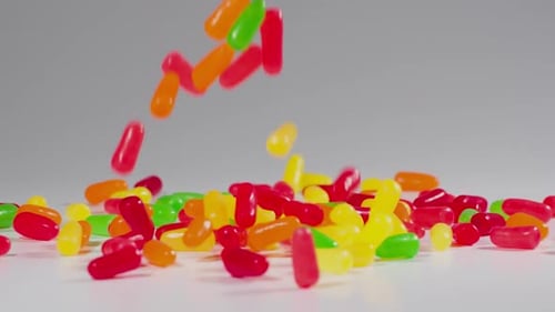 Colorful candy falls in slow motion