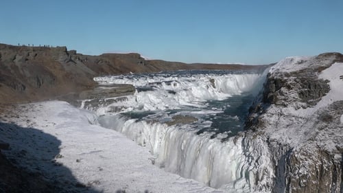 Iceland. Majestic waterfall in Iceland in the winter cover by snow and ice. Cascade of waterfall.