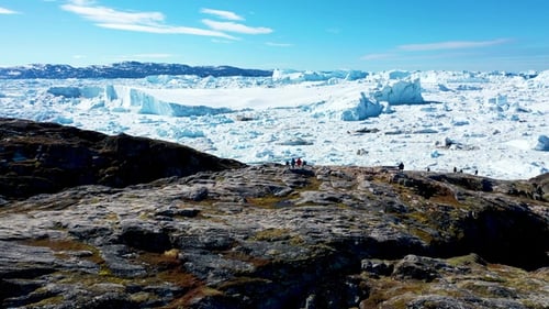 Arctic Landscape with Majestic Icebergs and Distant People