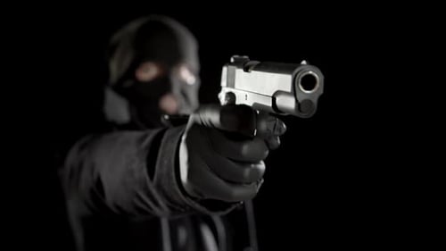 Masked Subject Aims Handgun in Dark Setting