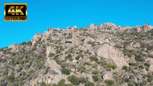 Rocky Mountain With Ancient Ruins and Hiker