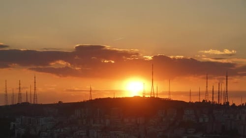 City Skyline with Communication Towers at Sunset