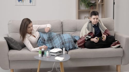 Sick Woman Uses Nebulizer as Boy Plays Video Game