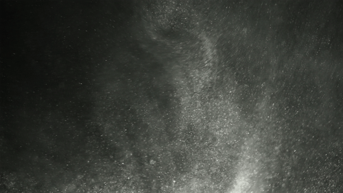 Floating Particles Against Dark Background