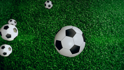 Football Ball On Green Grass Field