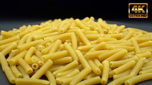 Heap of Uncooked Pasta on Dark Surface