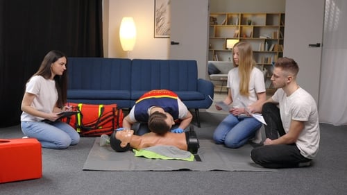 CPR Training Demonstration with Mannequin in Classroom