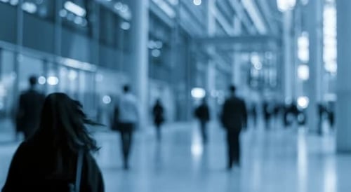 Blurred People Walking in Modern Hallway