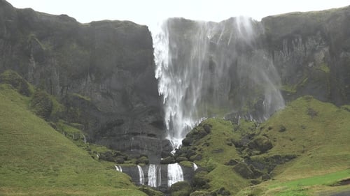Waterfall in Iceland. Spectacular Icelandic waterfall. The harsh beauty of the Arctic nature.
