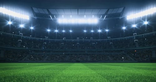 Sports Video background with a stadium full of fans, grass pitch and with spotlights on.