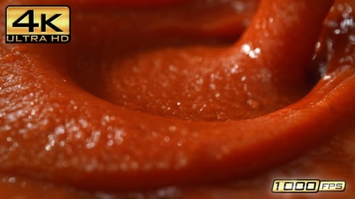 Vibrant Red Pizza or Spaghetti Tomato Sauce Poured into a Pan Creating a Splash and Smooth Wave