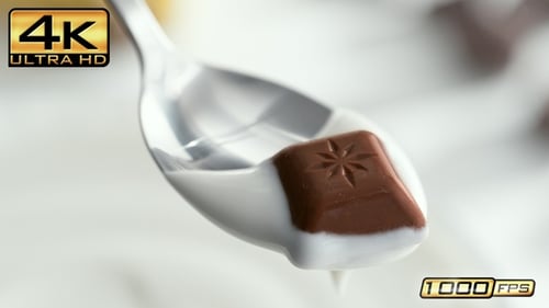 Chocolate Square Melting in Milk with Spoon
