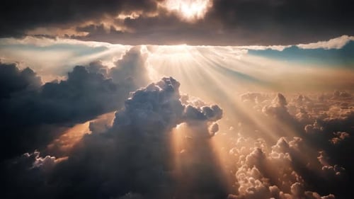 An aerial shot above beautiful sunset clouds with sun shining through fog, detailed picturesque view