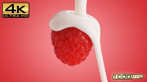Raspberry Being Covered in White Creamy Liquid