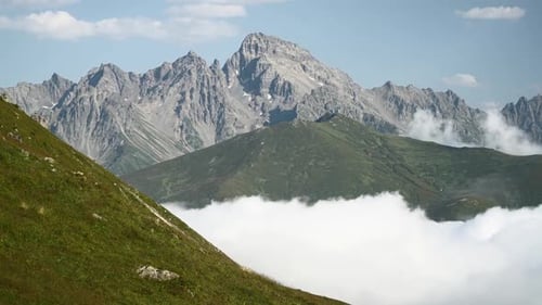 8K High Rocky Peaks Above The Clouds Covering Valley