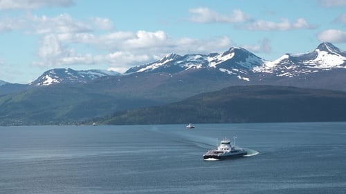 Cruise through islands and mountains with a ferry on a sunny day in a beautiful coastal area