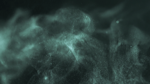 Smooth green dust particles fly in the air in close-up