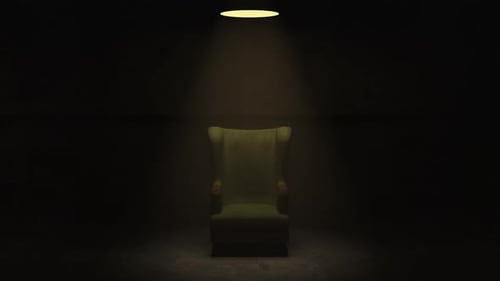 Dramatic Spotlight Reveals Spinning Wingback Chair in Dark Room