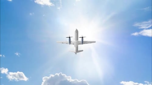 White Airplane Flying into Bright Sunny Sky