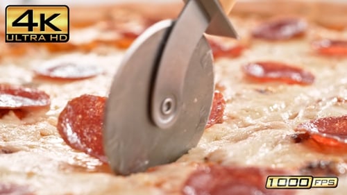New York Style Pepperoni Pizza Sliced With Pizza Cutter In Slow Motion And Macro