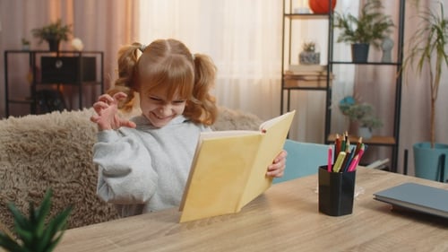 Young Girl Reacts to a Book in Her Home