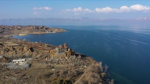 Medieval stone monastery on the shore of Lake Sevan. Aerial view church in Armenia. Famous place.