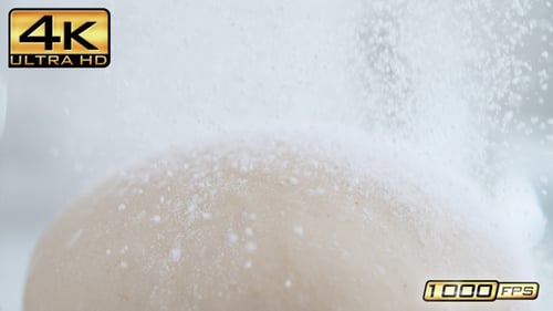 White Dough Ball with Flour on Bright Surface