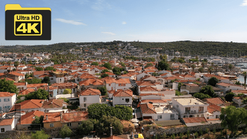 Aerial shot of historical Sigacik castle over old houses towards Teos marina