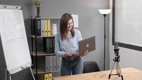 Woman with Laptop in Home Office Recording Video