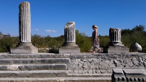 Woman Walking Among The Historical Ruins