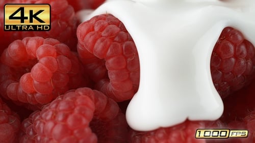 Cream Pours Over Fresh Ripe Red Raspberries