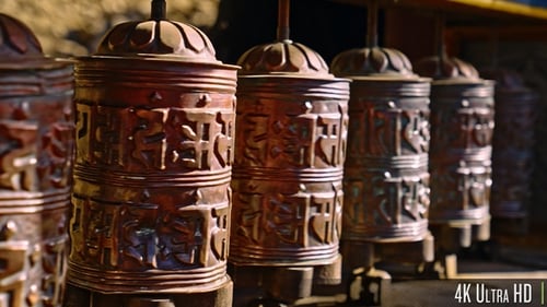 4K Group of religious prayer wheels spinning around in slow motion