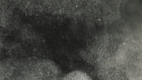 Beautiful sand dust particles soar up close up