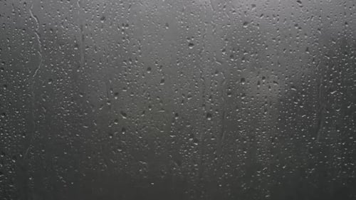Rain Drops Flowing Down Window Pane