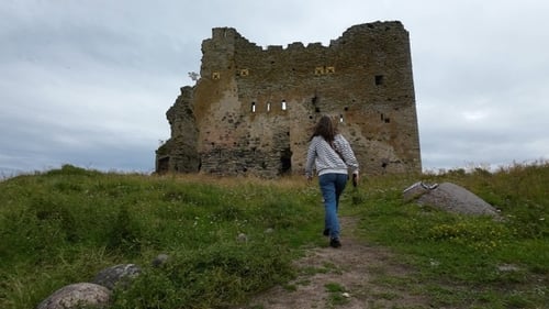 Girl goes to the old dilapidated castle. Slow motion.