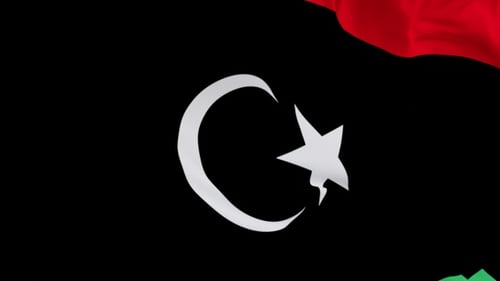 The Libya flag with alpha channel waving in the wind in slow motion