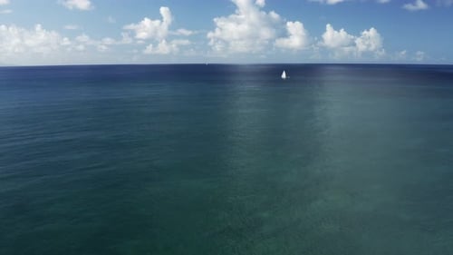 Sailboat alone in turquoise ocean in Martinique