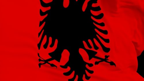 The Albania flag with alpha channel waving in the wind in slow motion
