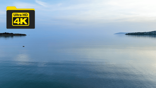 drone view of the still sea moving towards the clouds