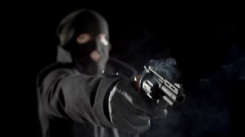 Masked Figure Fires Revolver in the Dark