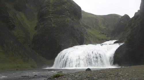 Waterfall in Iceland. Spectacular Icelandic waterfall. The harsh beauty of the Arctic nature.